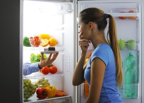 buzdolabında tatlı düşünen kadın